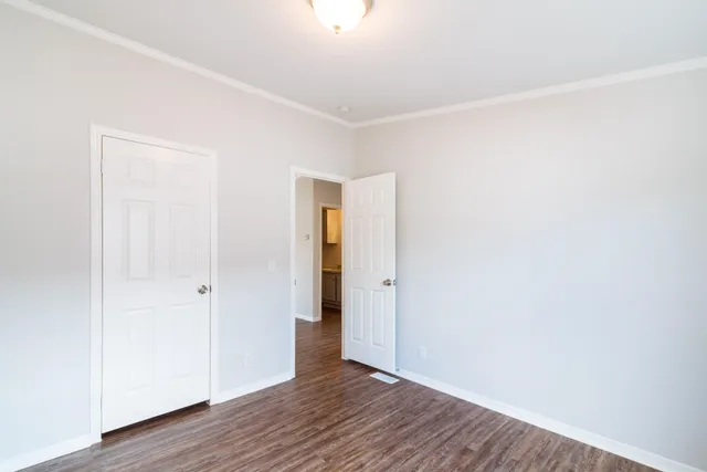 a view of an empty room with wooden floor
