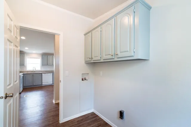 a view of a kitchen with wooden floor and a sink