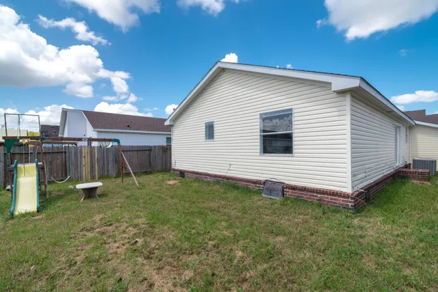 a view of a backyard of the house