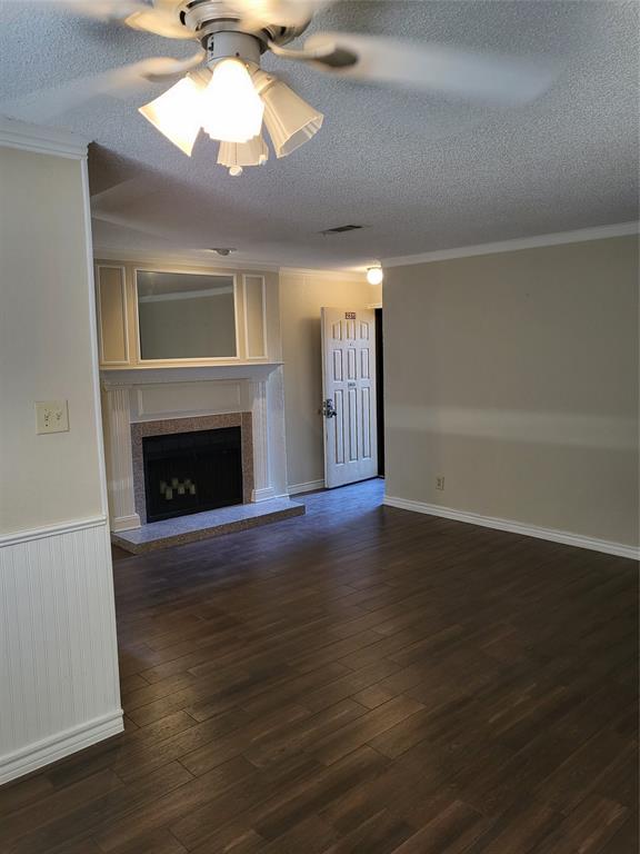 2010 Cloisters Drive, Unit 2311 Arlington, TX 76011 - Photo 1 of 24 a view of a livingroom with a fireplace a chandelier and wooden floor