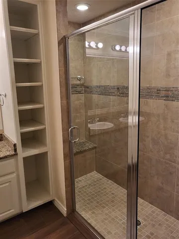 a bathroom with a glass shower door