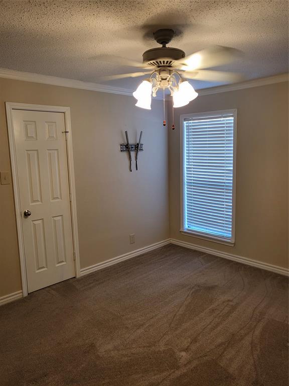2010 Cloisters Drive, Unit 2311 Arlington, TX 76011 - Photo 18 of 24 an empty room that has a chandelier fan