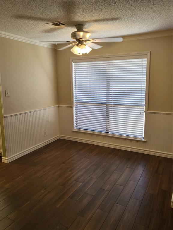 2010 Cloisters Drive, Unit 2311 Arlington, TX 76011 - Photo 4 of 24 a view of an empty room with wooden floor and a window