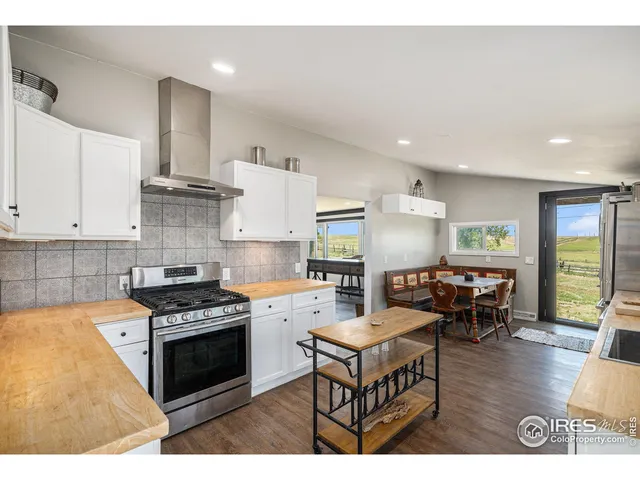 a kitchen with stainless steel appliances granite countertop a stove and a refrigerator