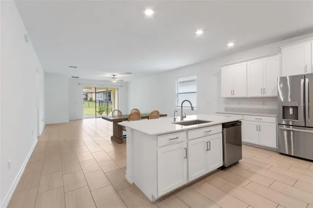 a kitchen with a sink window and stainless steel appliances