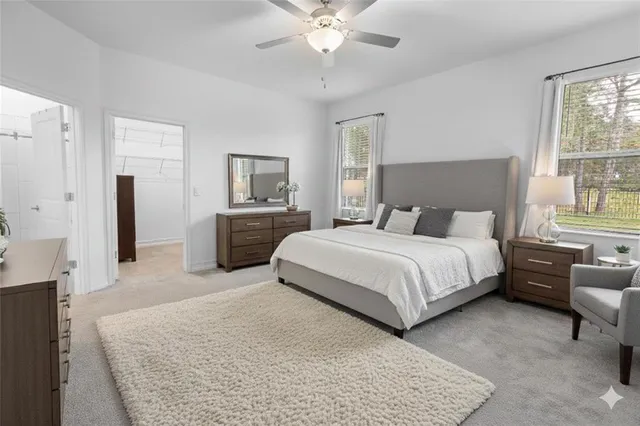 a bedroom with a large bed and a chandelier