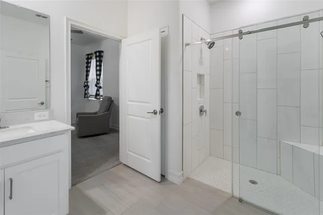 a bathroom with a granite countertop sink a toilet and shower