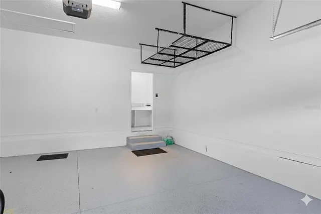 a view of a backyard with couches plants and large trees