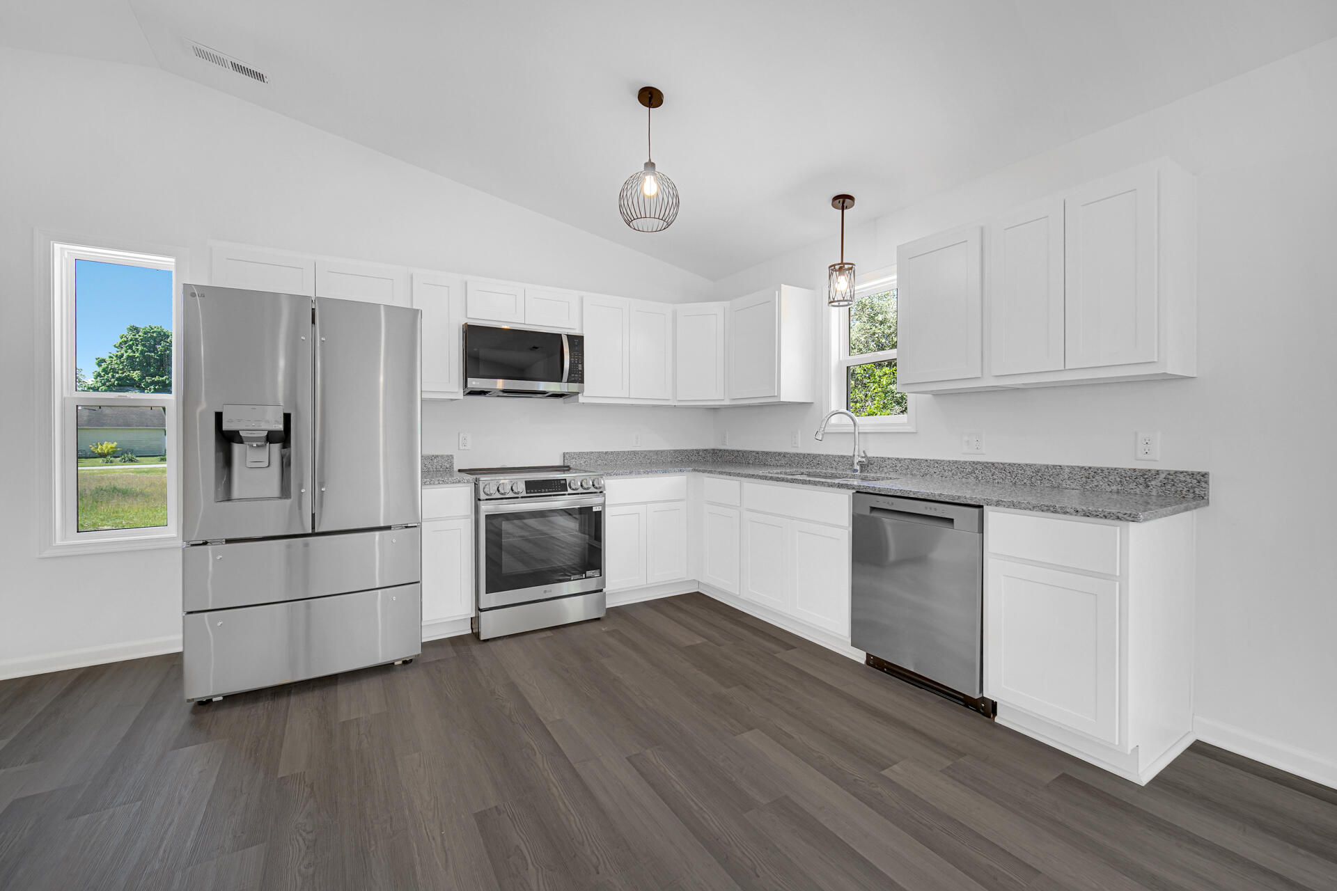 301 Malvern Road Kingsford Heights, IN 46346 - Photo 4 of 13 a kitchen with granite countertop white cabinets and white appliances