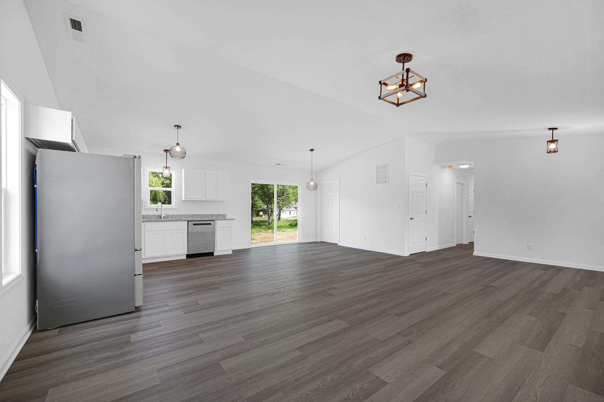 301 Malvern Road Kingsford Heights, IN 46346 - Photo 7 of 13 a view of an empty room with a window and wooden floor