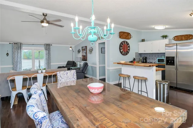 a room with kitchen island a wooden floor and white appliances