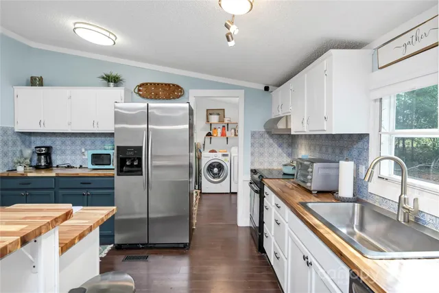 a kitchen with a sink cabinets and window