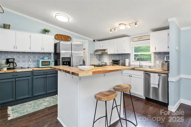 a living room with furniture a flat screen tv and a large window