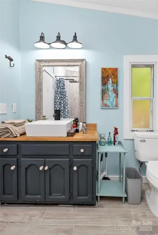 a bathroom with a sink a vanity and a mirror