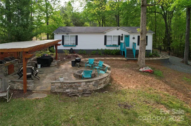 a view of a patio with table and chairs and a barbeque