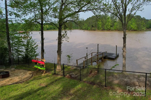 an aerial view of a house with a yard and lake view