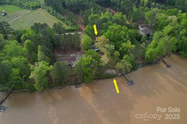 an aerial view of a houses with a lake view