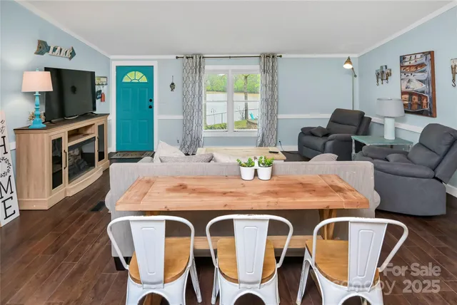 a living room with furniture a flat screen tv and a large window