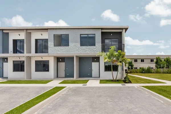 a house view with swimming pool and yard in front of it