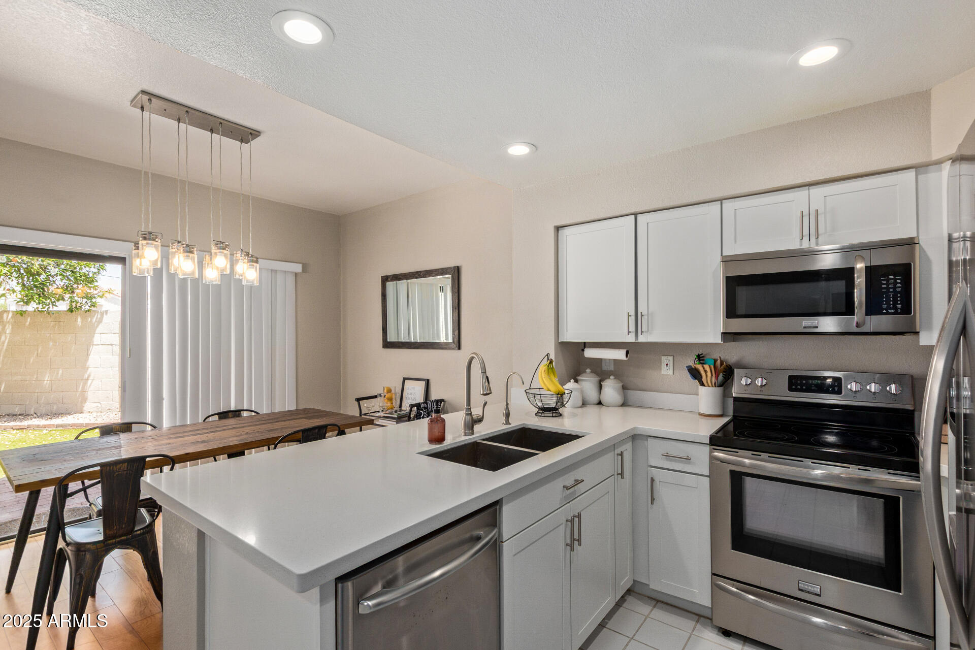 7716 South Rita Lane Tempe, AZ 85284 - Photo 12 of 31 a kitchen that has a sink and a stove top oven