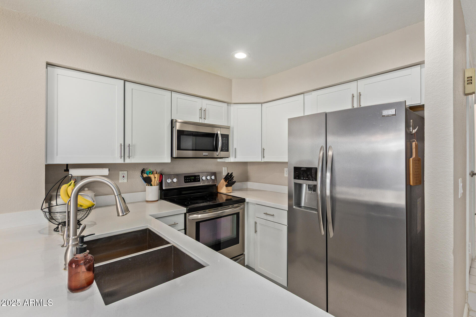 7716 South Rita Lane Tempe, AZ 85284 - Photo 14 of 31 a kitchen with a refrigerator and a sink