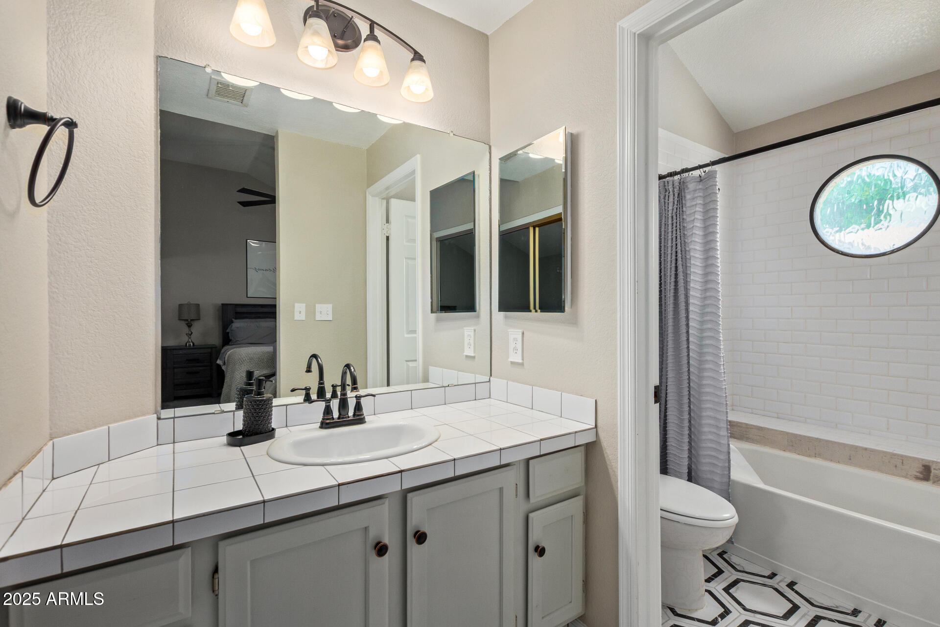 7716 South Rita Lane Tempe, AZ 85284 - Photo 18 of 31 a bathroom with a double vanity sink toilet and a mirror