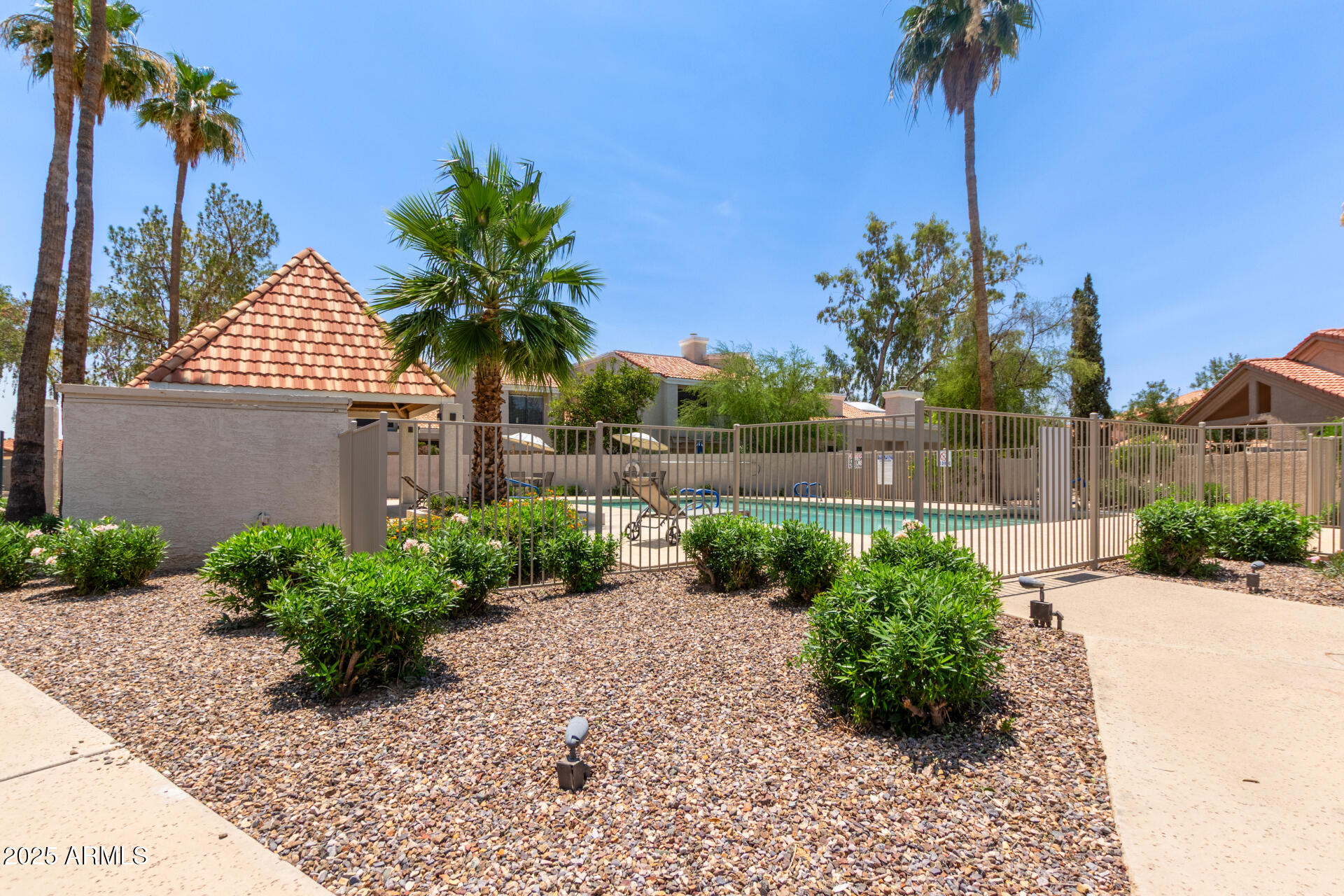 7716 South Rita Lane Tempe, AZ 85284 - Photo 29 of 31 a front view of a house with a yard and potted plants