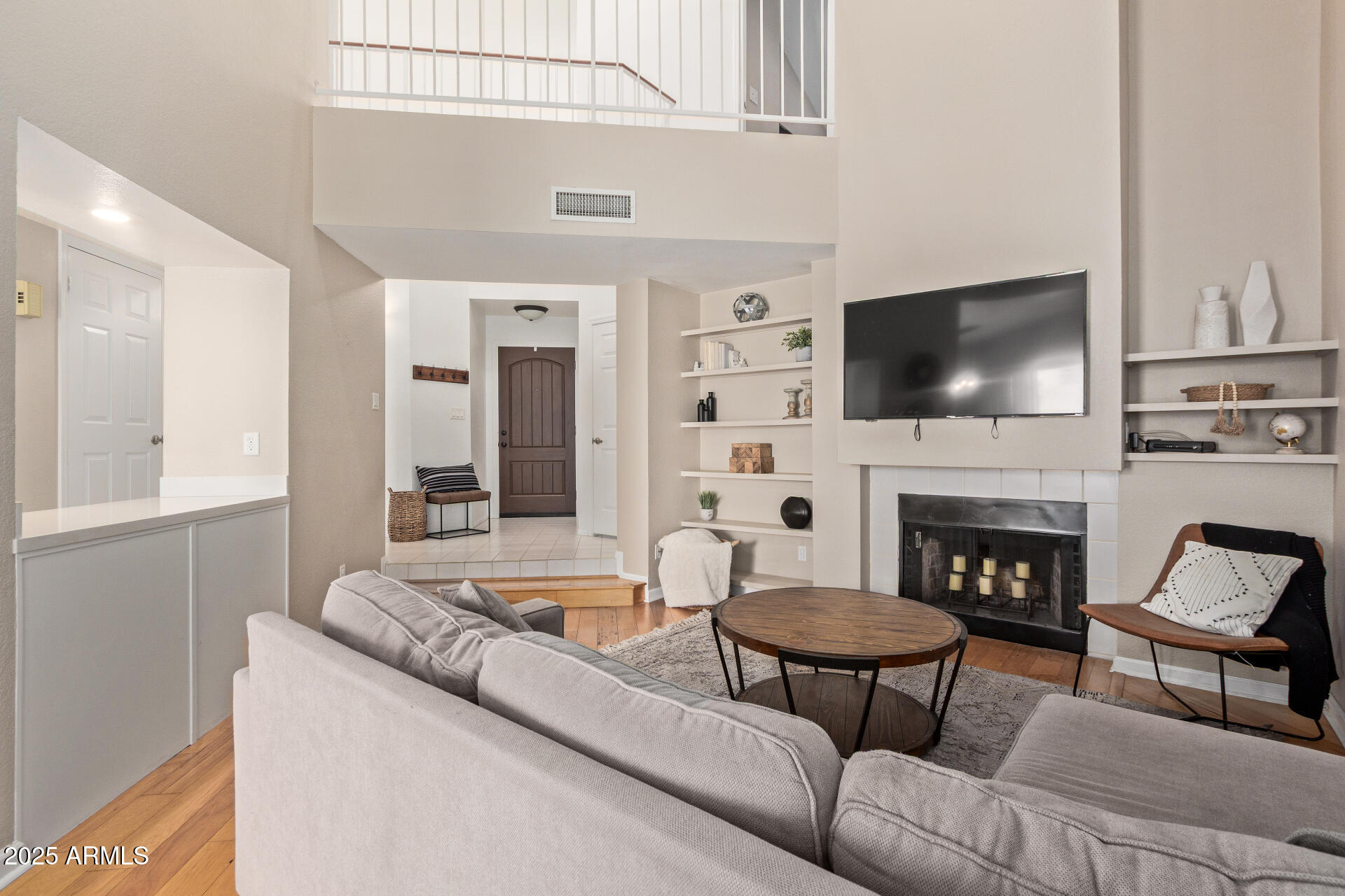 7716 South Rita Lane Tempe, AZ 85284 - Photo 4 of 31 a living room with furniture a fireplace and a flat screen tv