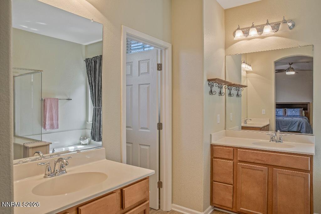 1864 Wind Ranch Road, Unit B Reno, NV 89521 - Photo 20 of 42 a bathroom with a sink and a mirror