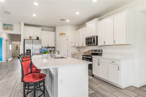 a kitchen with stainless steel appliances granite countertop a sink and cabinets