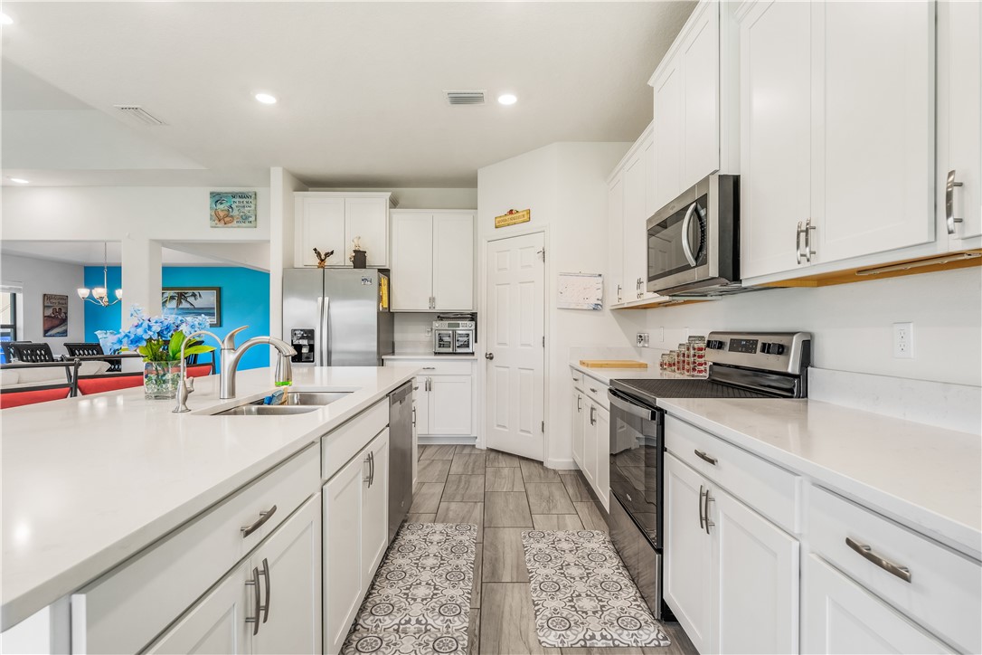 5760 1st Road Vero Beach, FL 32968 - Photo 12 of 36 a kitchen with stainless steel appliances granite countertop a sink and cabinets
