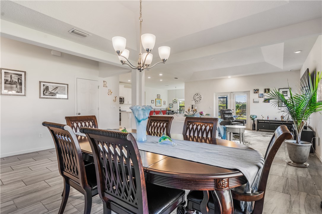 5760 1st Road Vero Beach, FL 32968 - Photo 18 of 36 a view of a dining room with furniture and wooden floor