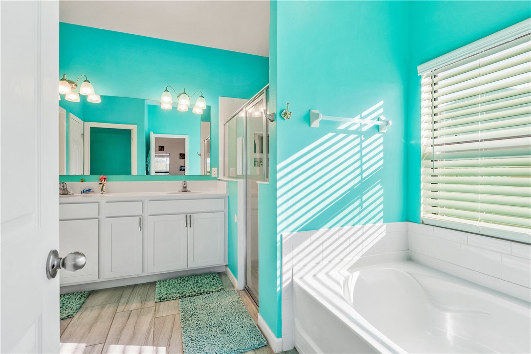 5760 1st Road Vero Beach, FL 32968 - Photo 21 of 36 a bathroom with a sink a mirror and a bathtub