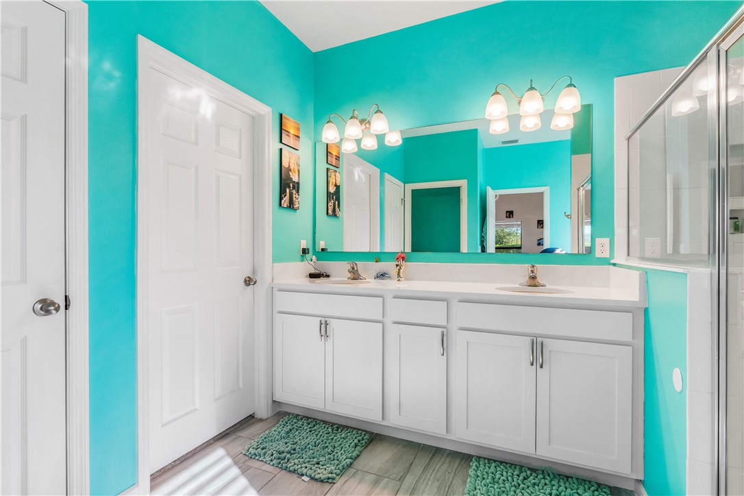 5760 1st Road Vero Beach, FL 32968 - Photo 22 of 36 a bathroom with a double vanity sink and a mirror