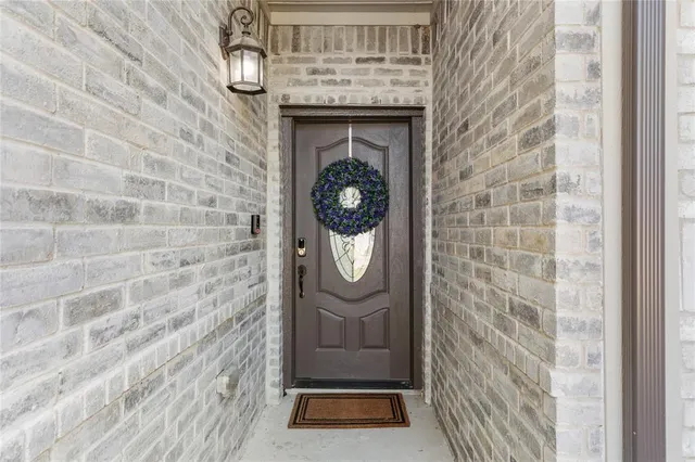 a kitchen with stainless steel appliances a dining table chairs and wooden floor