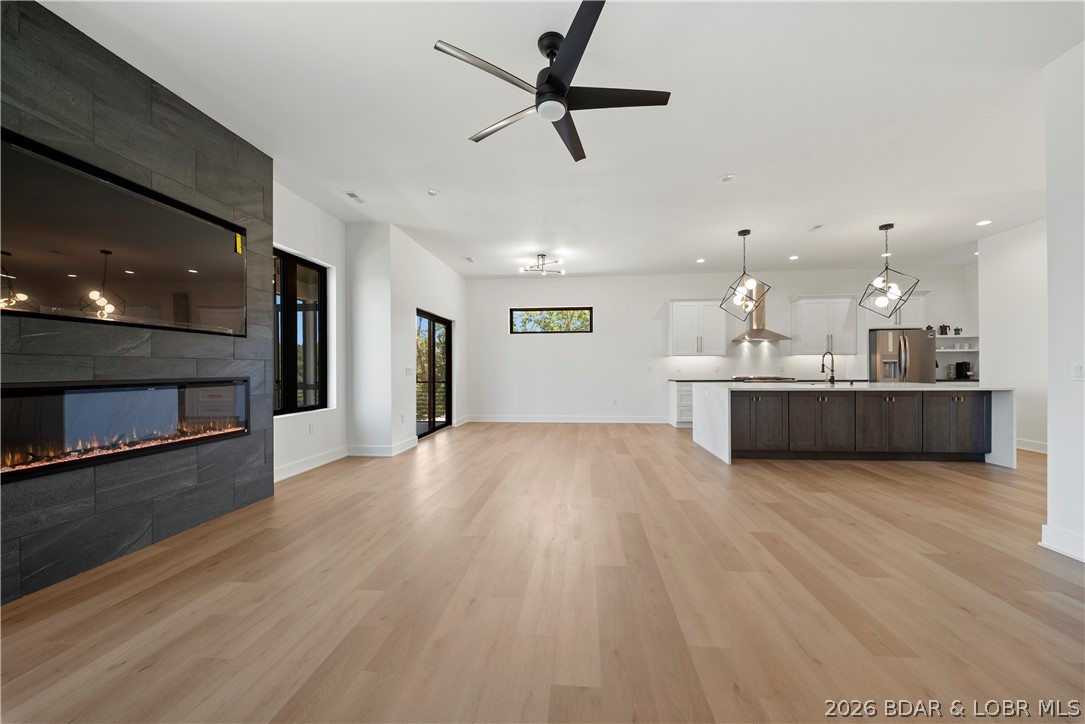 222 Red Bud Road Lake Ozark, MO 65049 - Photo 19 of 64 Spacious living room highlighted by a modern firep