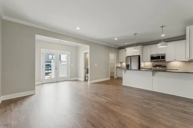a open kitchen with kitchen island and stainless steel appliances