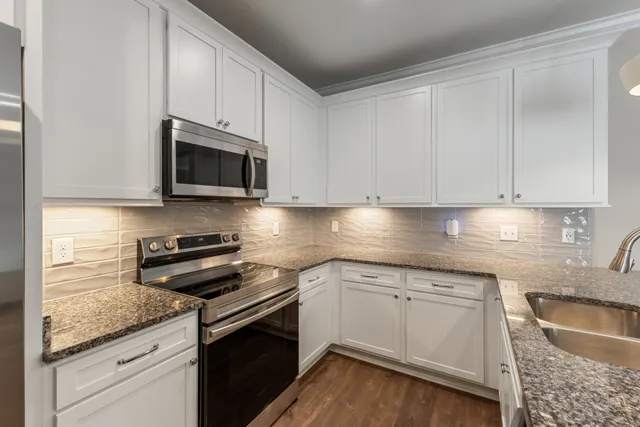 a bathroom with a sink mirror and toilet