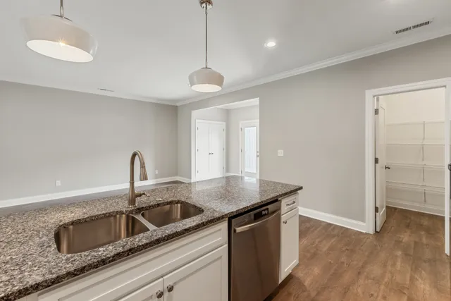a view of an empty room with closet and a window