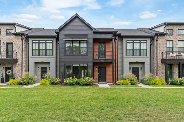 a front view of a house with a yard and porch