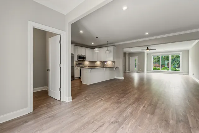 a spacious bedroom with a bed and a chandelier