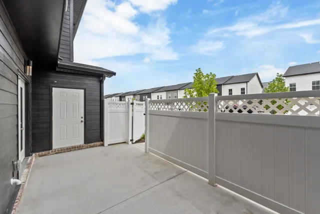 an aerial view of residential houses with outdoor space and trees