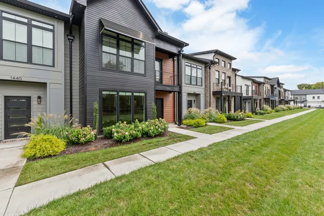 a front view of a house with garden and porch