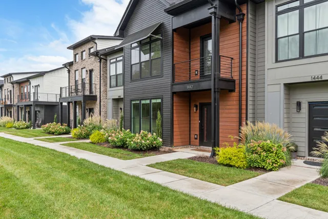 a front view of a brick house with a yard