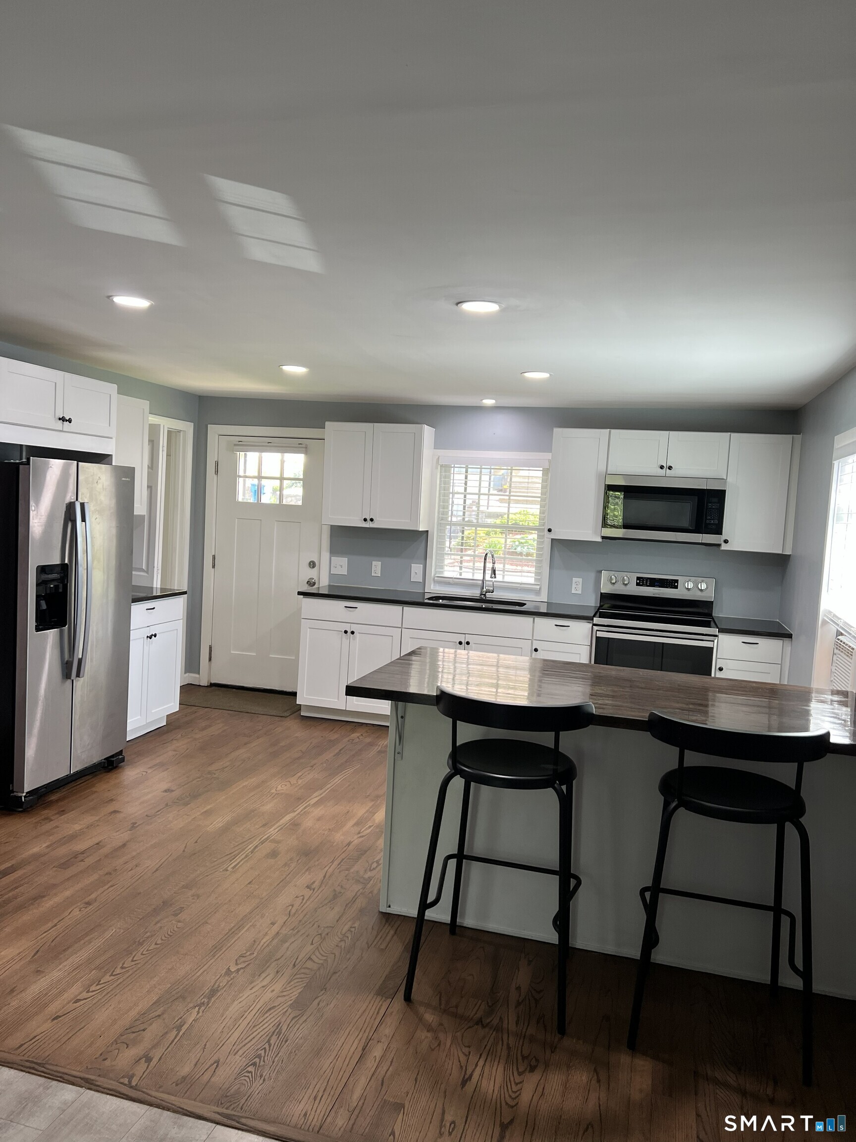 82 Bingham Street Bristol, CT 06010 - Photo 7 of 40 a kitchen with stainless steel appliances a stove a sink a refrigerator and cabinets