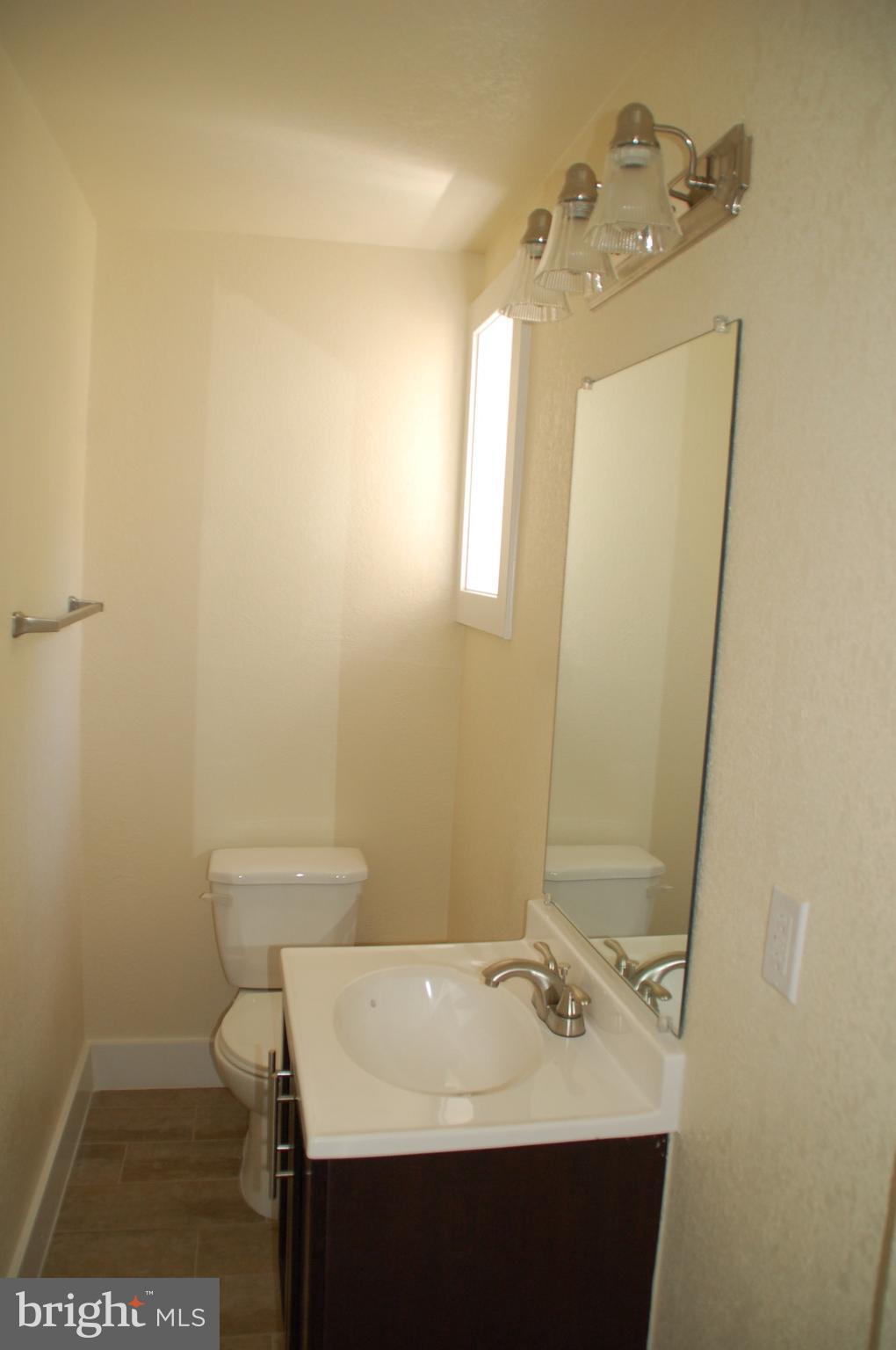 202 Westshire Road Baltimore, MD 21229 - Photo 22 of 28 a bathroom with a sink and a mirror