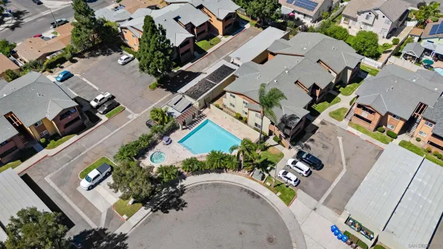an aerial view of residential houses with outdoor space and swimming pool