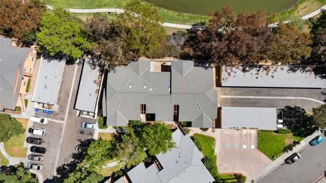 an aerial view of a house with a yard and tree s