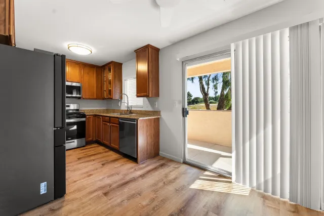 a kitchen with stainless steel appliances a stove top oven and sink