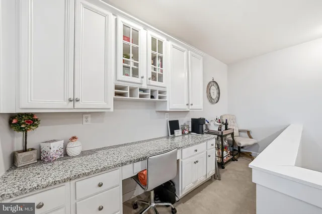 a kitchen with granite countertop a sink a stove and cabinets